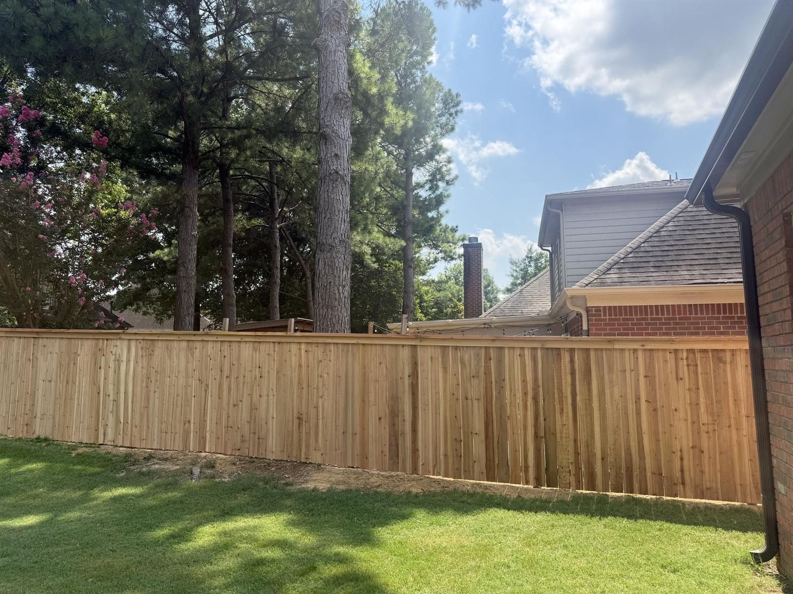 Completed wood privacy fence in a Memphis-area backyard